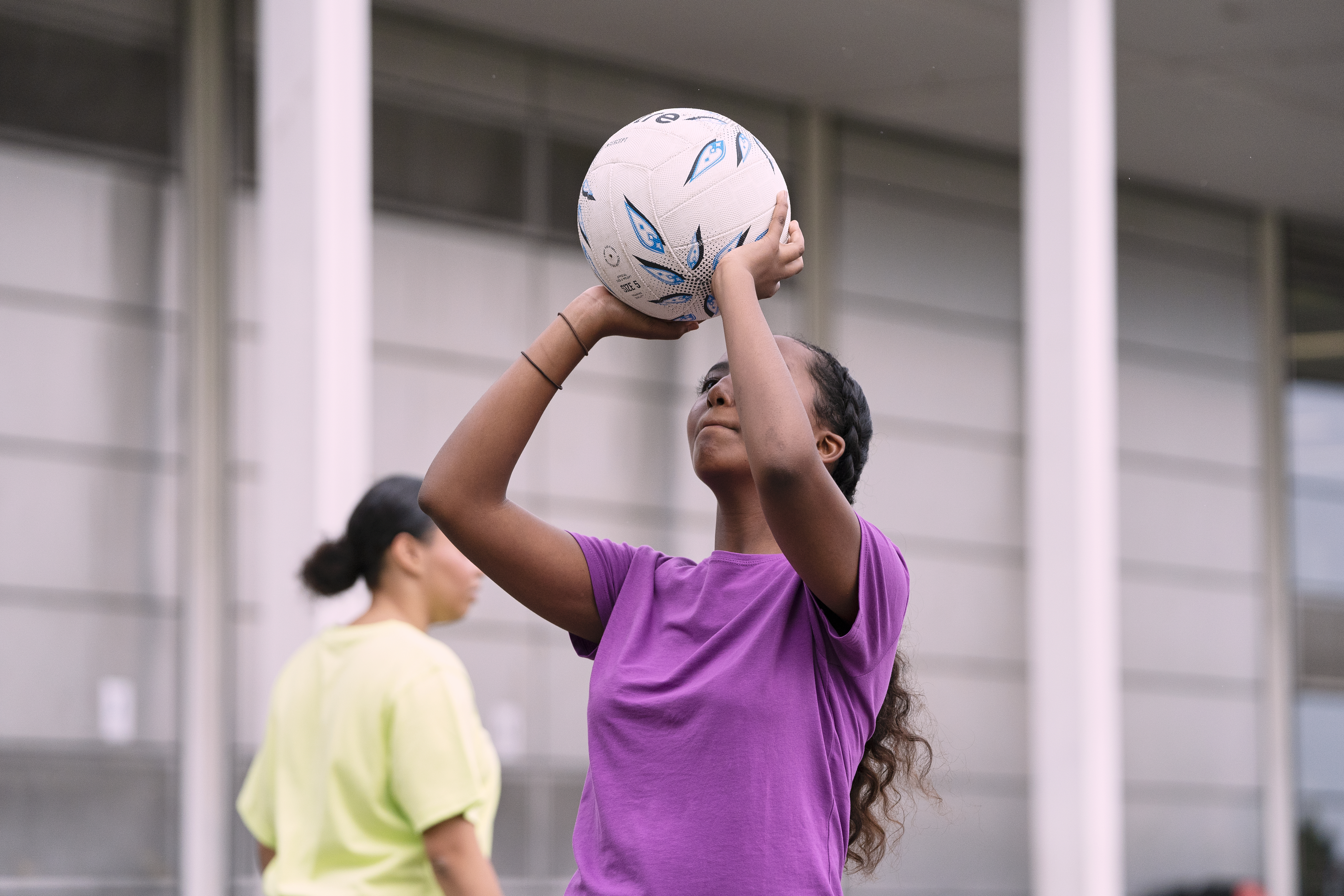 a girl about to take a shot in net ball
