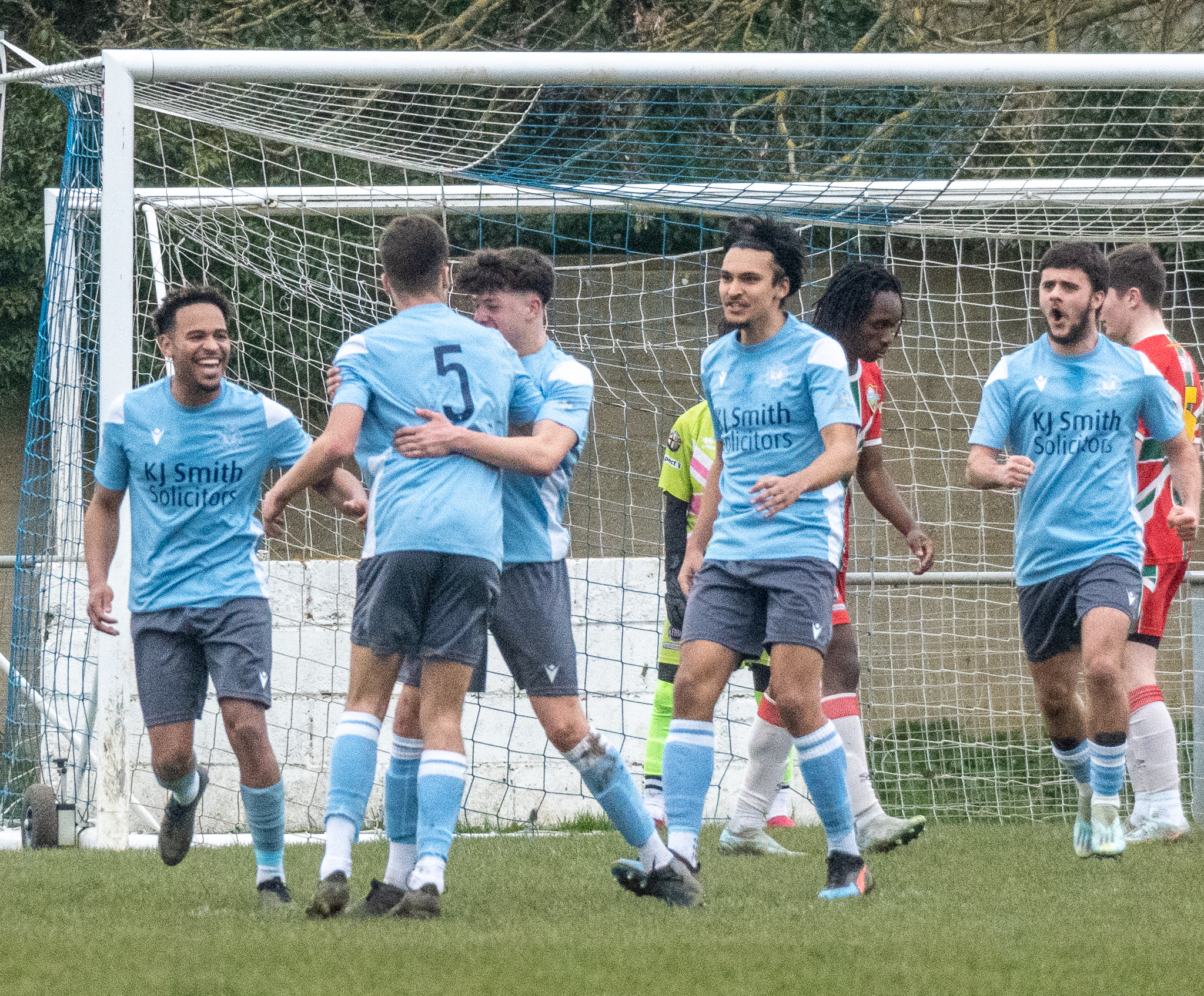 Woodley United men's teams celebrating after scoring a goal